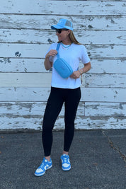 Meredith Hudson, founder of Sideline Bags, wearing the crossbody bag in Carolina blue.