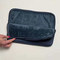 13" zippered laptop sleeve with a single compartment in navy blue.