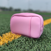 Pink travel organizer pouch out on the field by Sideline Bags.