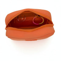 Orange travel organizer pouch from Sideline Bags featuring internal compartments.