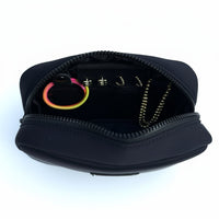 Black travel organizer pouch with internal compartments from Sideline Bags.