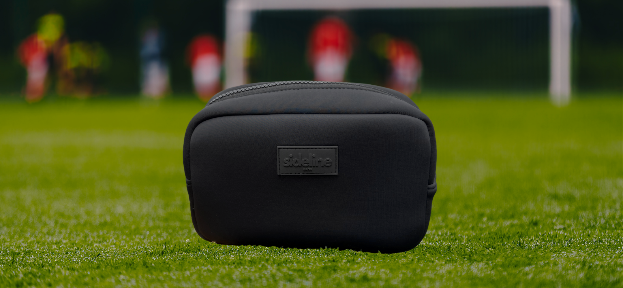 During a sports event, a black travel organizer pouch takes to the field from Sideline Bags.