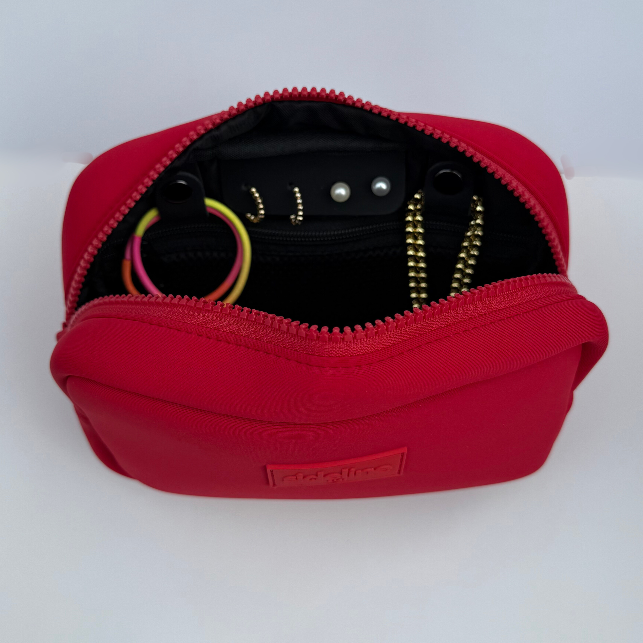 Red travel organizer pouch with internal compartments from Sideline Bags.